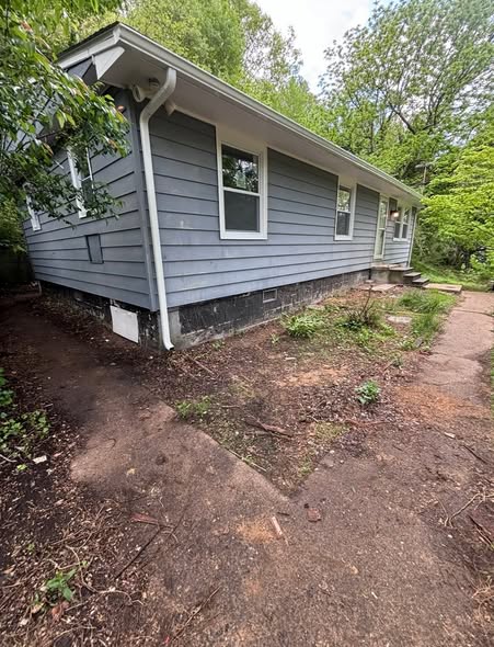 Before: house exterior with worn siding