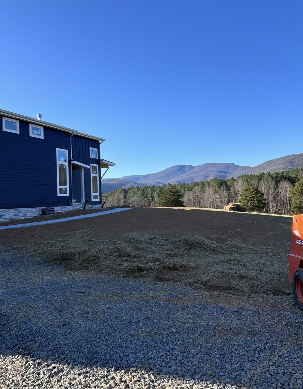 Finished blue house with mountain view