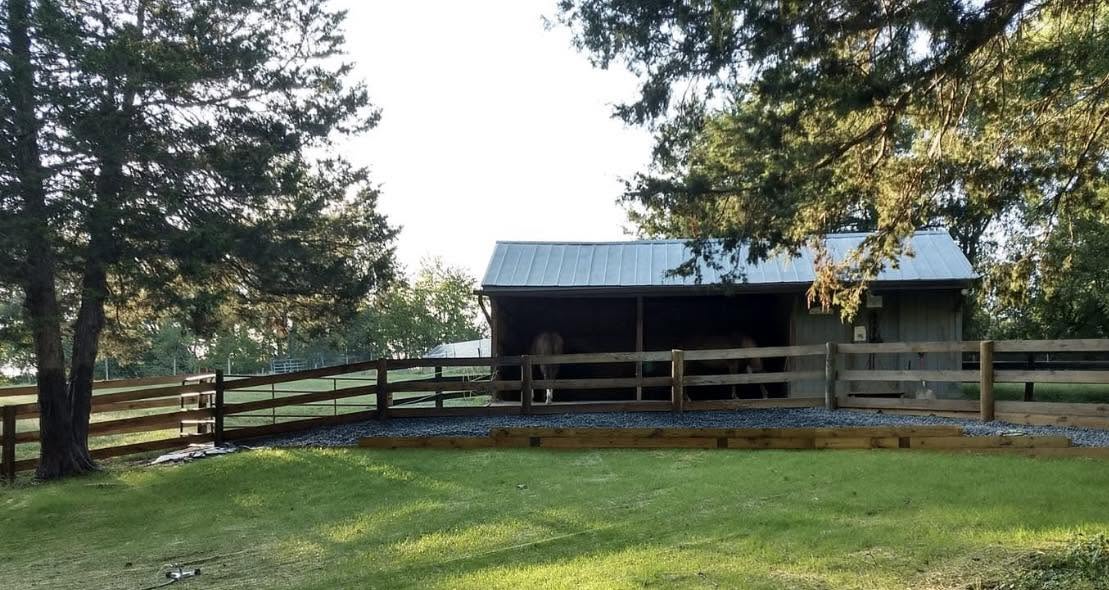After: horse barn with new fencing and landscaping